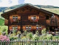 Traditional Swiss country house with cottage garden. St. Antoenien, Grisons, Switzerland. Royalty Free Stock Photo