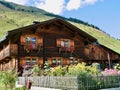 Traditional Swiss country house with cottage garden. St. Antoenien, Grisons, Switzerland. Royalty Free Stock Photo