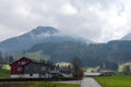 Traditional Swiss landscape with rural houses against the background of mountains.