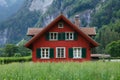 Traditional swiss manor red country house in switzerland with lush green surroundings