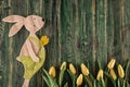 Traditional symbol of spring season like yellow tulips and bunny on wooden background, happy easter time Royalty Free Stock Photo