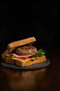 Traditional Taiwan local breakfast ,hamburger with pork steak,hams lettuce tomatos and egg and with black pepper tomato sause