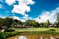 Traditional Tana Toraja village, tongkonan houses and buildings. Sunny, blue sky with clouds, lake in a foreground. Kete Kesu, Ran