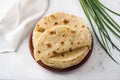 Traditional Tatar flatbread, kastyby and a bunch of green onions on a light gray background, top view Royalty Free Stock Photo