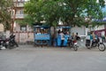 Traditional tea house in the streets of India. Tea vendor preparing tea and buyer maintaining distance with mask on face. India Royalty Free Stock Photo