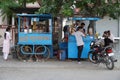 Traditional tea house in the streets of India. Tea vendor preparing tea and buyer maintaining distance with mask on face. India Royalty Free Stock Photo