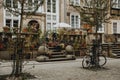 Traditional terrace in front of the old house with lots of flowers in historical center of the polish city Gdansk with bicycle lea Royalty Free Stock Photo