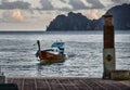 Traditional Thai boat swims to the pier