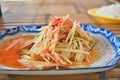 The Traditional Thai food papaya salad prepared with fine slices of papaya, tomatoes, green beans and peanuts Royalty Free Stock Photo