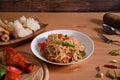 Traditional Thai food papaya salad  in white plate on wooden background. Royalty Free Stock Photo