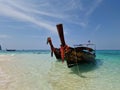 Traditional thai longtail boats parked on the shore