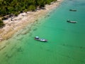 Traditional Thai Longtail fishing boats anchored off a small, palm tree lined tropical beach (Khao Lak, Thailand Royalty Free Stock Photo