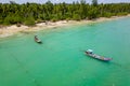 Traditional Thai Longtail fishing boats anchored off a small, palm tree lined tropical beach (Khao Lak, Thailand Royalty Free Stock Photo