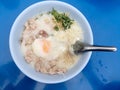 Traditional thai porridge rice gruel in white bowl, congee. In the street night market. Royalty Free Stock Photo