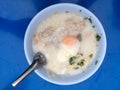 Traditional thai porridge rice gruel in white bowl, congee. In the street night market. Royalty Free Stock Photo