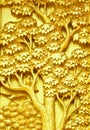 Traditional Thai style art golden tree carving on temple door Royalty Free Stock Photo