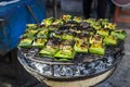 Marinate fish in banana leaf on the grill at the food market in Thailand Royalty Free Stock Photo