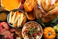 Traditional Thanksgiving day feast with delicious cooked turkey and other seasonal dishes as background, top view Royalty Free Stock Photo