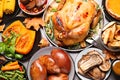 Traditional Thanksgiving day feast with delicious cooked turkey and other seasonal dishes served on grey table, flat lay Royalty Free Stock Photo