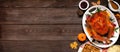 Traditional Thanksgiving turkey dinner. Overhead side border on a dark wood banner background.