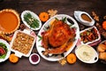 Traditional Thanksgiving turkey dinner overhead table scene on dark wood