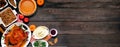 Traditional Thanksgiving turkey dinner. Top down view corner border on a dark wood banner background. Royalty Free Stock Photo