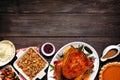 Traditional Thanksgiving turkey dinner. Top view bottom border on a dark wood background with copy space.