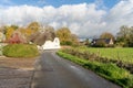 Traditional thatched cottage on a rural road through the village of Tarrant Monkton, Dorset, UK Royalty Free Stock Photo