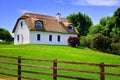 Thatched roof cottage house in Ireland under blue skies Royalty Free Stock Photo