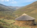 Traditional thatched stone round hut of the Basutho in the mountain highlands of Lesotho, Southern Africa