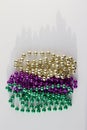 Traditional three color Mardi Gras beads abstract design on white background Royalty Free Stock Photo