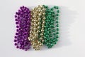 Traditional three color Mardi Gras beads abstract design on white background Royalty Free Stock Photo