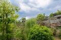 Traditional tile-roofed buildings on riverside cliff in cloudy s Royalty Free Stock Photo