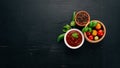 Traditional tomato ketchup sauce. Cherry tomatoes, spices, chili peppers, olive oil, parsley. Top view. Royalty Free Stock Photo