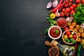 Traditional tomato ketchup sauce. Cherry tomatoes, spices, chili peppers, olive oil, parsley. Top view. Royalty Free Stock Photo