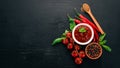 Traditional tomato ketchup sauce. Cherry tomatoes, spices, chili peppers, olive oil, parsley. Top view. Royalty Free Stock Photo