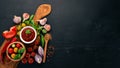 Traditional tomato ketchup sauce. Cherry tomatoes, spices, chili peppers, olive oil, parsley. Top view. Royalty Free Stock Photo
