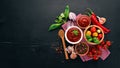 Traditional tomato ketchup sauce. Cherry tomatoes, spices, chili peppers, olive oil, parsley. Top view. Royalty Free Stock Photo