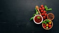 Traditional tomato ketchup sauce. Cherry tomatoes, spices, chili peppers, olive oil, parsley. Top view. Royalty Free Stock Photo