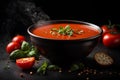 Traditional tomato soup with basil in a bowl on dark background. Commercial promotional food photo