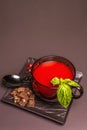 Traditional tomato soup in a cup. Basil, croutons, spices, cutlery Royalty Free Stock Photo