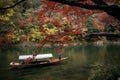 Traditional touris travel boat on the river in Kyoto city with autumn season background Royalty Free Stock Photo