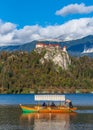 Traditional tourist boat on lake under Bled castle in Slovenia