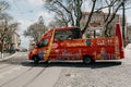 A traditional tourist minibus rides a city street in Lisbon