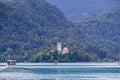 Bled - Traditional touristic wooden Pletna rowing boat driving to St Mary Church of Assumption build on small island