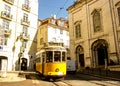 A traditional tram `elÃÂ©ctrico` from Lisbon down Rua da Madalena and passing in front of the Church of Madalena