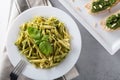 Traditional trofie pasta with pesto sauce on white plate