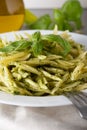 Traditional trofie pasta with pesto sauce on white plate