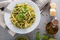 Traditional trofie pasta with pesto sauce on white plate