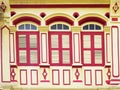 Traditional tropical louvred wooden red windows Royalty Free Stock Photo